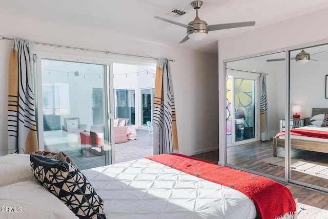 bedroom featuring ceiling fan, dark hardwood / wood-style flooring, and a closet