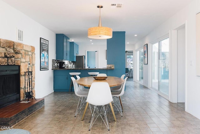 dining area featuring a fireplace