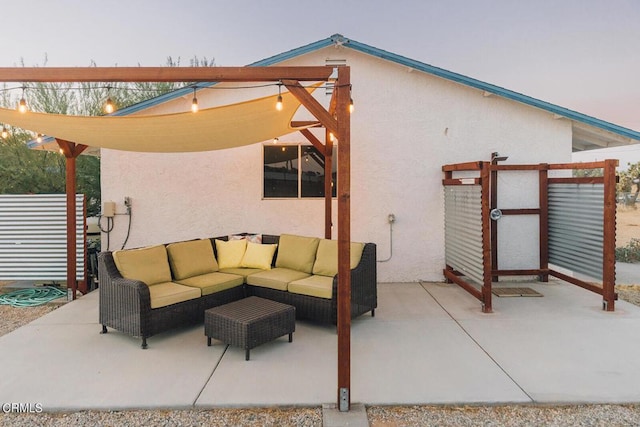 patio terrace at dusk featuring an outdoor living space