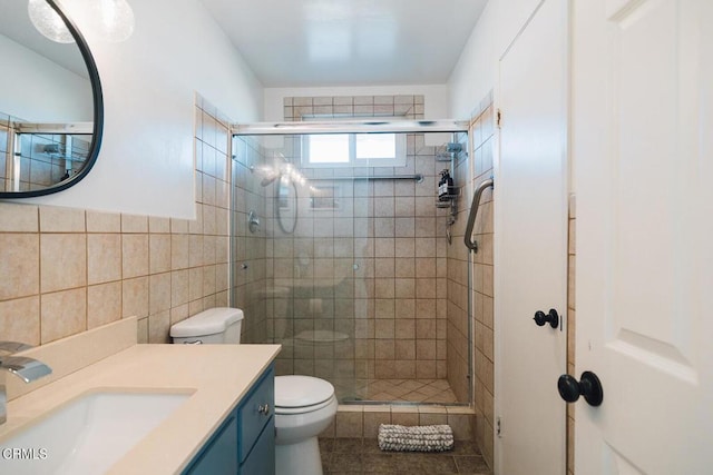 bathroom featuring backsplash, an enclosed shower, toilet, vanity, and tile walls