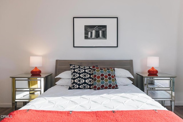 bedroom with dark hardwood / wood-style floors