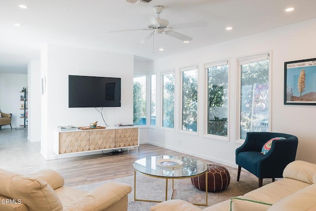 living room featuring hardwood / wood-style flooring and ceiling fan