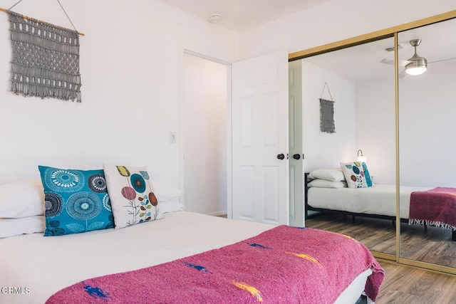 bedroom with a closet and hardwood / wood-style flooring