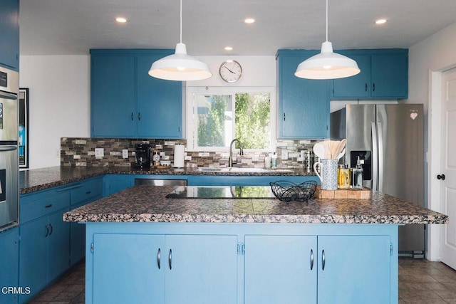 kitchen featuring a center island, tasteful backsplash, blue cabinets, and hanging light fixtures