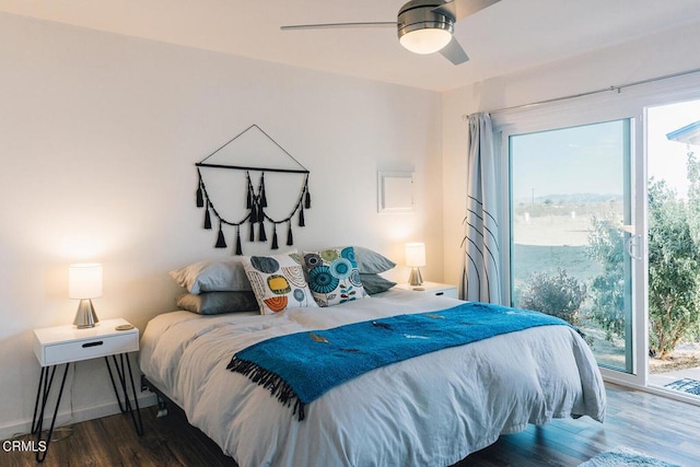 bedroom featuring access to exterior, ceiling fan, and dark wood-type flooring