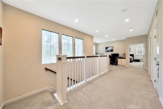 hallway with light colored carpet