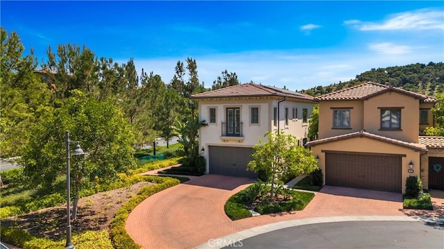 mediterranean / spanish-style house with a garage