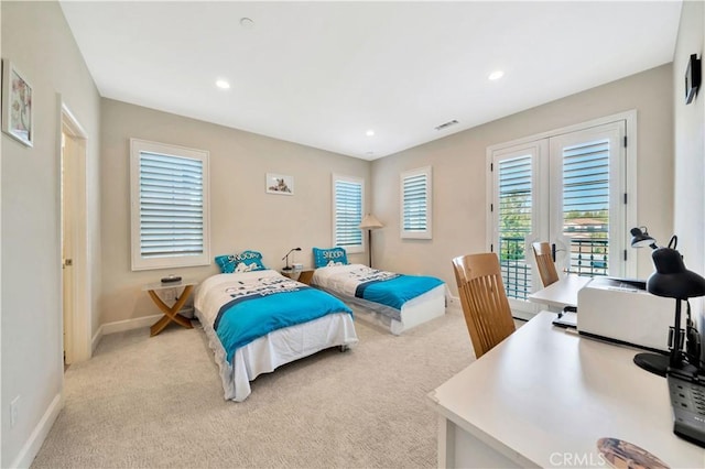 bedroom with light colored carpet and access to outside