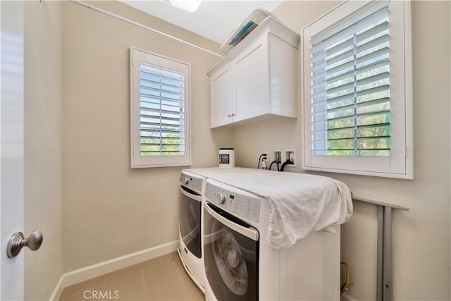 washroom with cabinets, separate washer and dryer, and light tile patterned floors