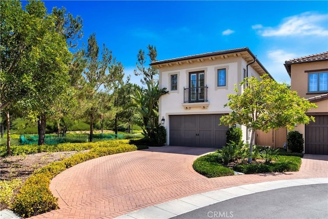 mediterranean / spanish-style house with a garage