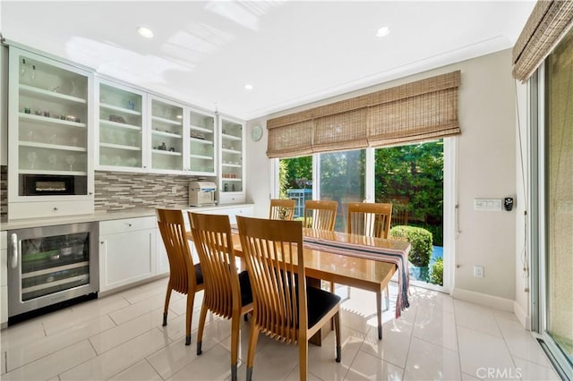 tiled dining space featuring wine cooler