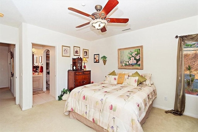 carpeted bedroom with ceiling fan and connected bathroom