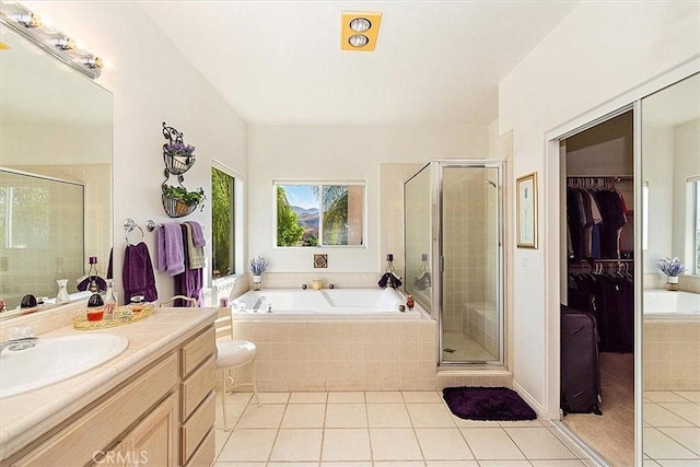 bathroom with tile patterned flooring, vanity, and independent shower and bath