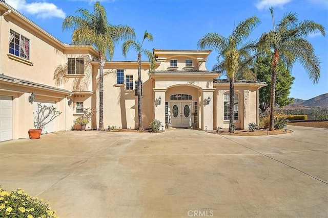 mediterranean / spanish-style home featuring a mountain view and a garage