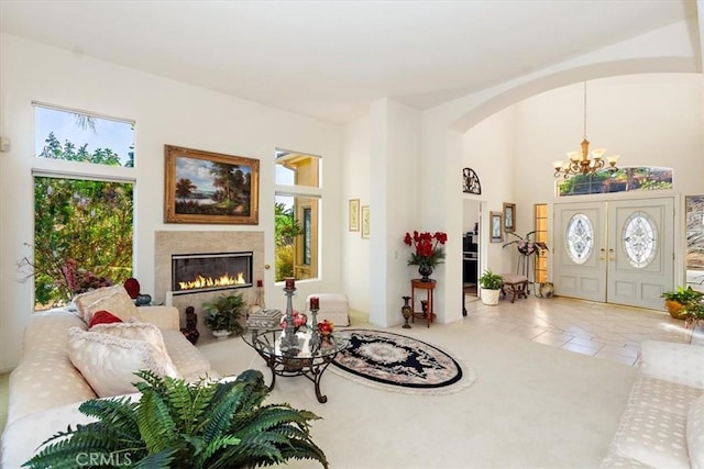 tiled living room featuring an inviting chandelier