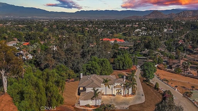 aerial view at dusk featuring a mountain view