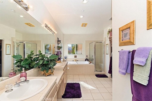 bathroom with tile patterned flooring, vanity, and separate shower and tub