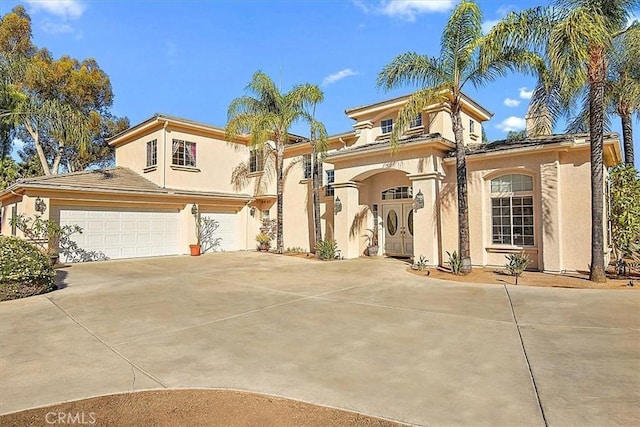 mediterranean / spanish house featuring a garage