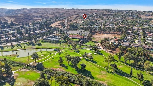 birds eye view of property with a water and mountain view