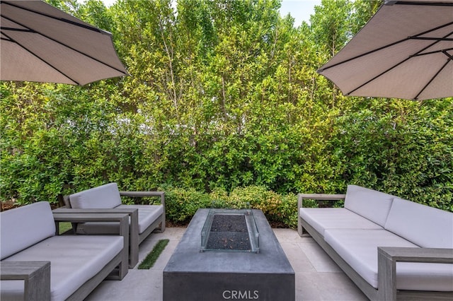 view of patio / terrace with an outdoor living space with a fire pit