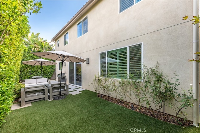 back of house featuring a lawn and a patio area