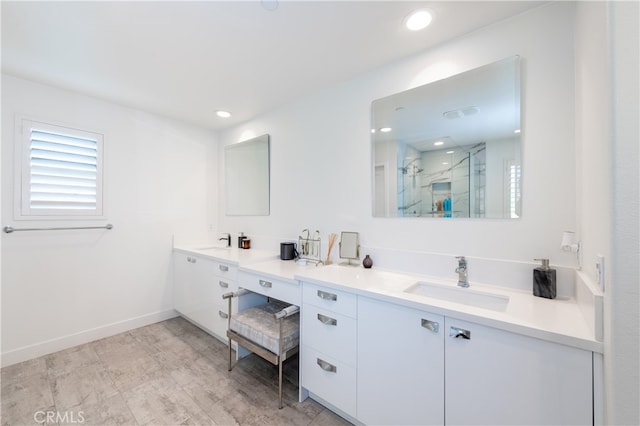 bathroom with a shower with door and vanity