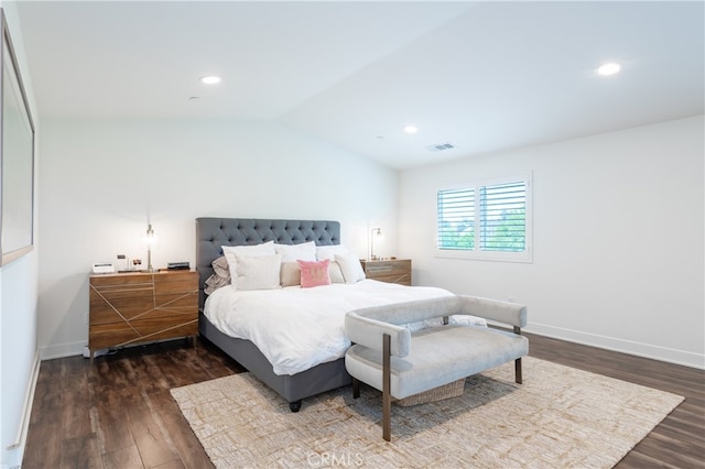 bedroom with vaulted ceiling and dark hardwood / wood-style floors