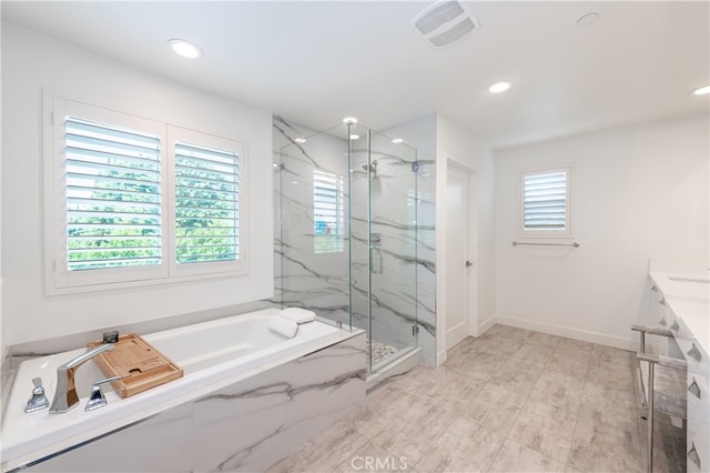 bathroom featuring shower with separate bathtub and vanity