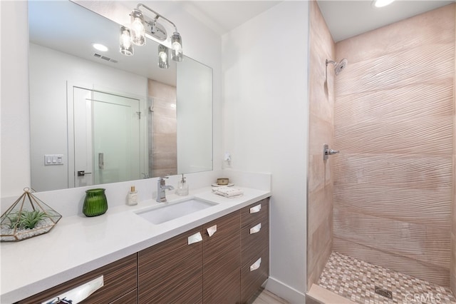 bathroom featuring vanity and tiled shower