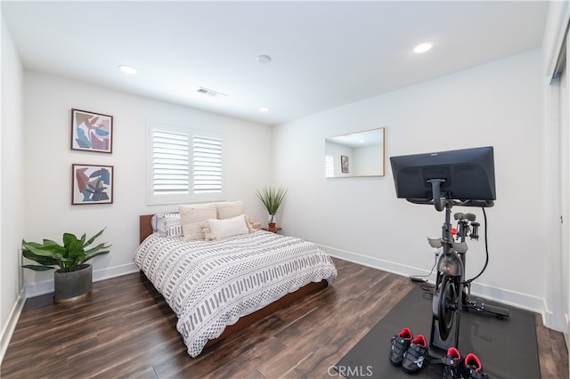 bedroom with dark hardwood / wood-style floors