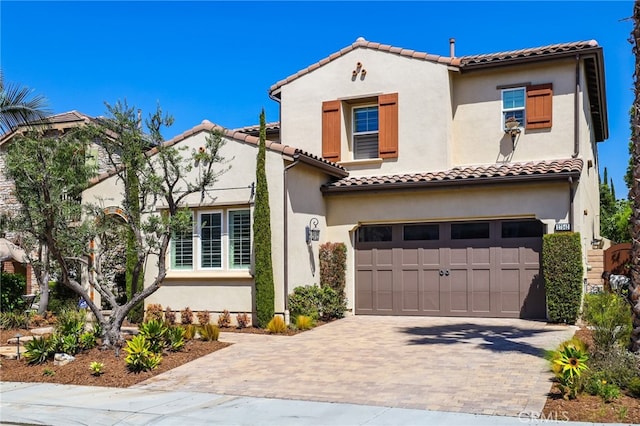 mediterranean / spanish-style home with a garage