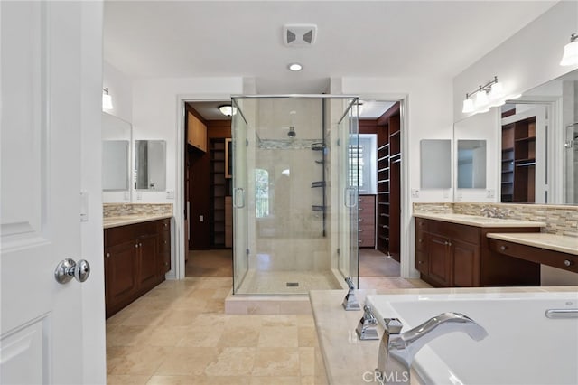 bathroom with tile patterned floors, vanity, independent shower and bath, and tasteful backsplash