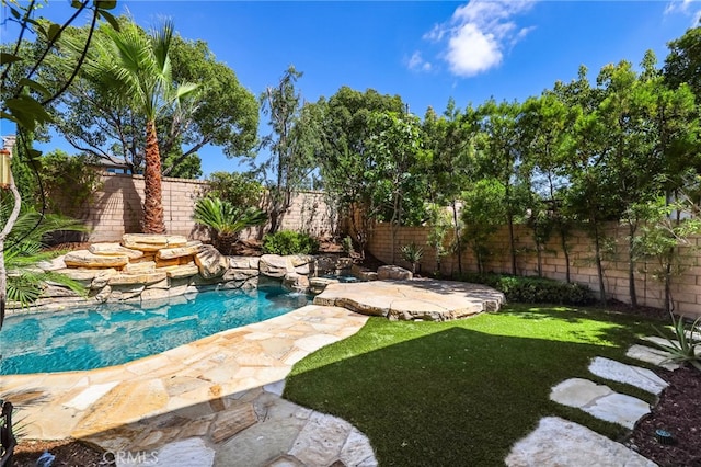 view of pool with a patio area and a lawn