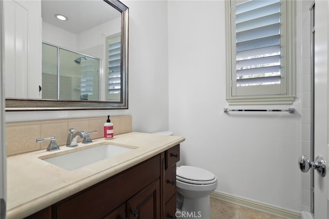 bathroom featuring tile patterned floors, vanity, toilet, and an enclosed shower