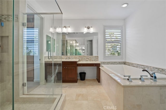 bathroom featuring shower with separate bathtub, vanity, and tile patterned floors