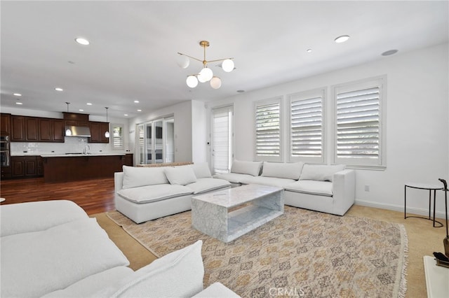 living room featuring a notable chandelier and light wood-type flooring