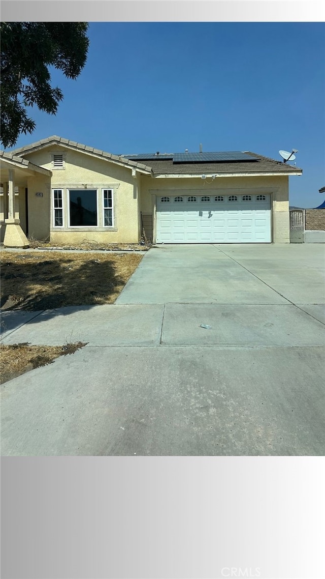 view of front of house with a garage and solar panels