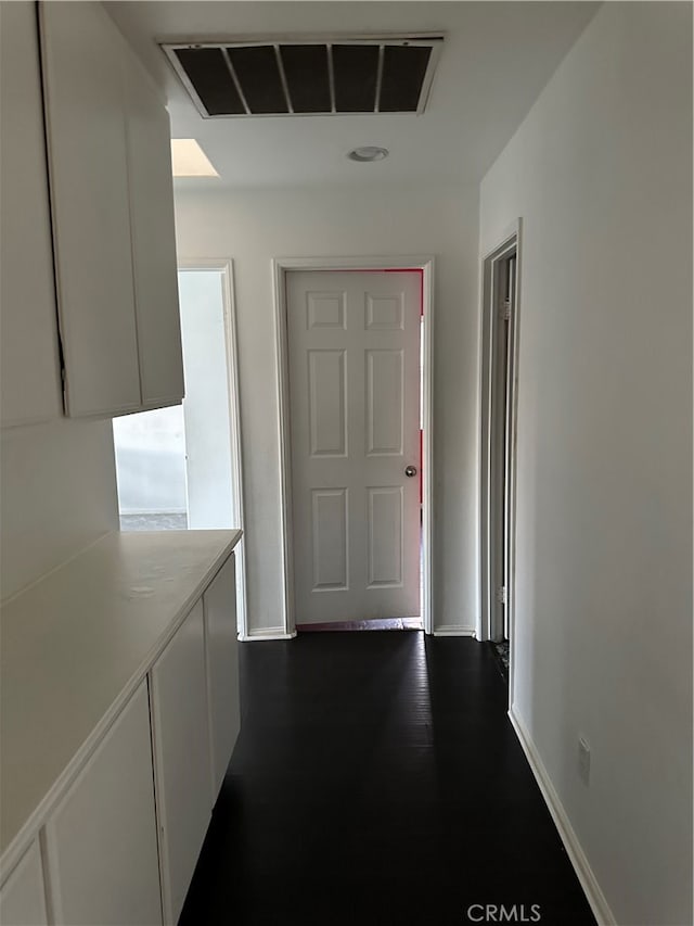 corridor featuring dark wood-type flooring