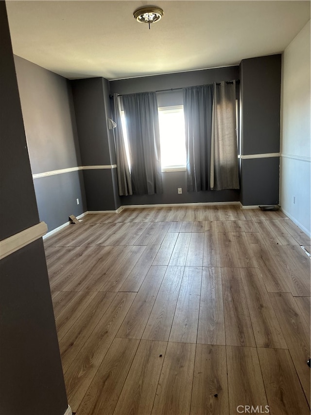 unfurnished room with light hardwood / wood-style flooring