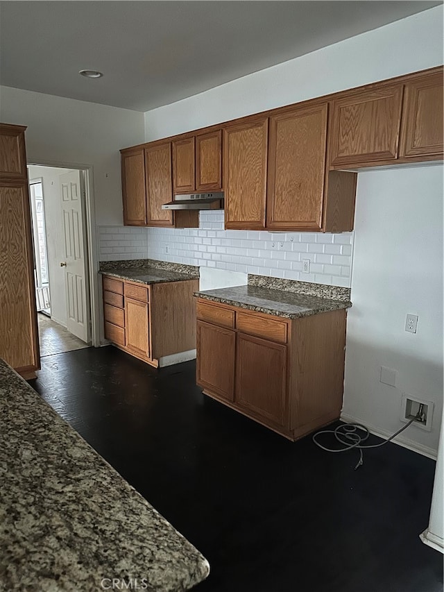 kitchen with decorative backsplash and dark hardwood / wood-style floors