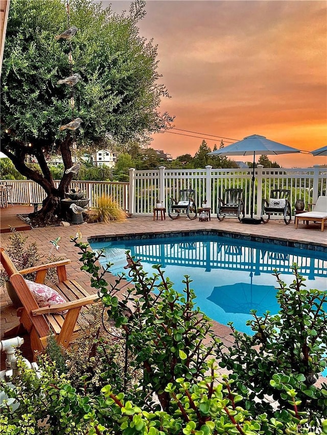 view of pool at dusk