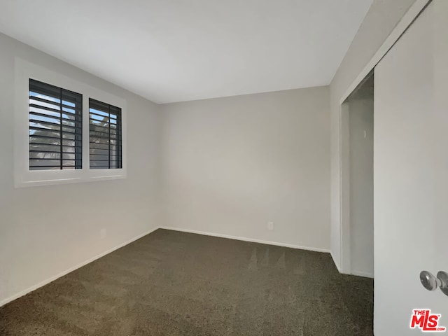 empty room with dark carpet