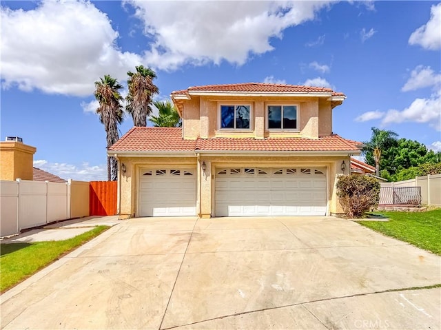 mediterranean / spanish home with a garage