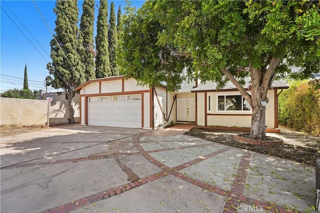 view of front of property featuring a garage and an outdoor structure