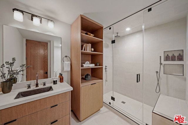 bathroom featuring tile patterned flooring, vanity, and an enclosed shower