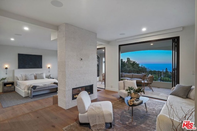 bedroom with a fireplace and hardwood / wood-style floors