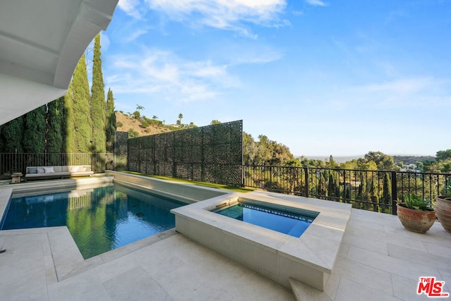 view of pool with an in ground hot tub and a patio