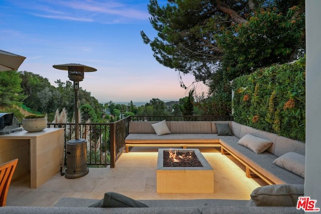 patio terrace at dusk with an outdoor fire pit