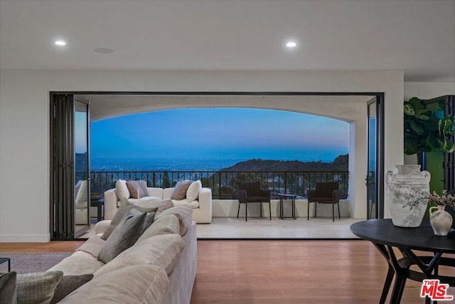 living room with hardwood / wood-style flooring, plenty of natural light, and a water view