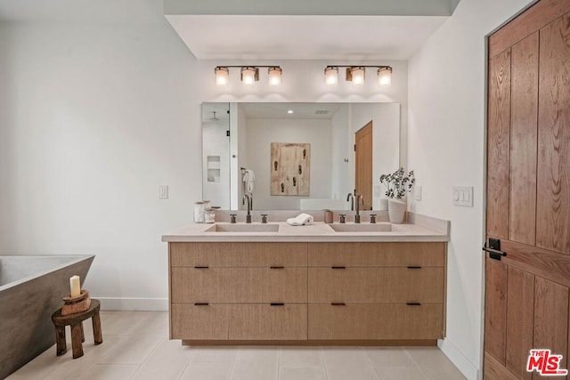 bathroom featuring vanity, tile patterned floors, and a tub